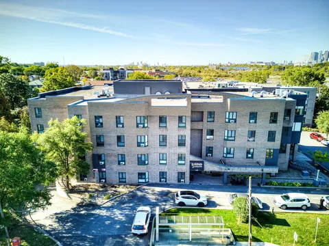 Elevated view of a residence wing and its surrounding grounds.