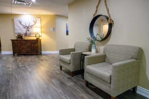 Lobby seating and console table beside the entrance corridor.
