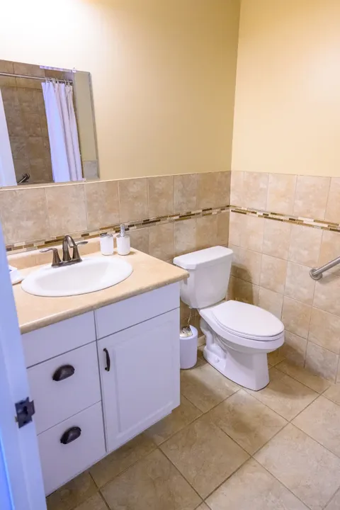 Bathroom with sink, mirror and toilet.