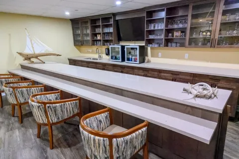Bar counter with stools and shelves.