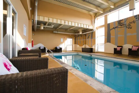 Indoor swimming pool beside large windows