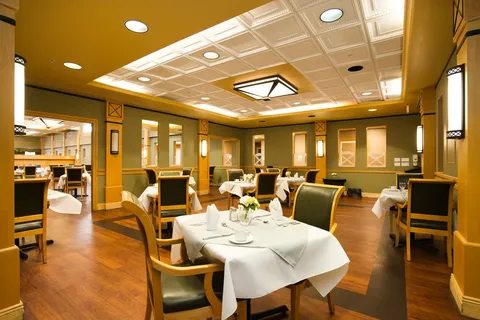Dining room with set tables and upholstered chairs