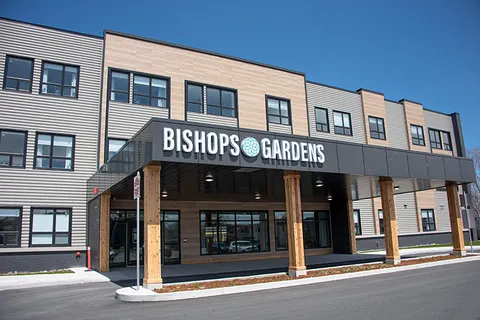 Front exterior with the covered entrance and parking area.