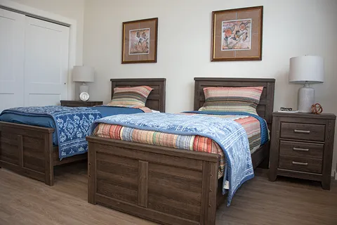 Twin-bed suite with matching bedside furniture.
