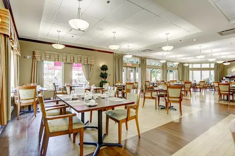 Dining room with set tables, chairs and large windows
