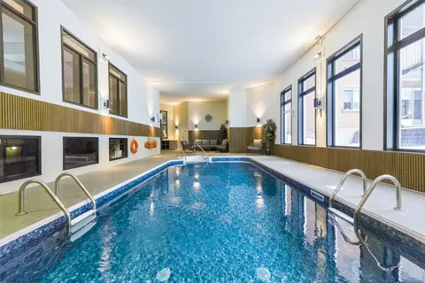 Indoor swimming pool beneath high windows