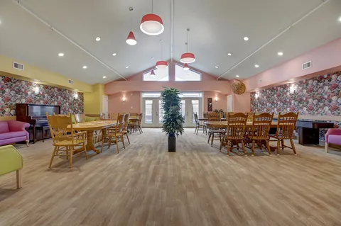 Dining room with round tables, wooden chairs and pendant lights