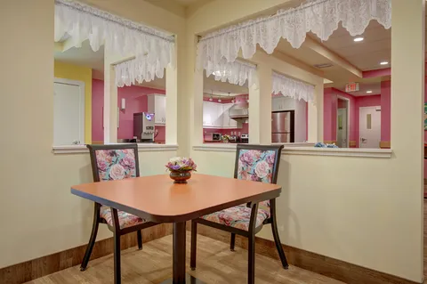 Table and chairs beside interior windows