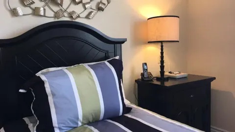 Bedroom with a bed and bedside furniture.
