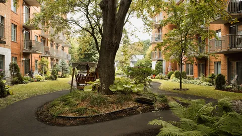 Garden paths, planted beds and covered bench swings beside the residence