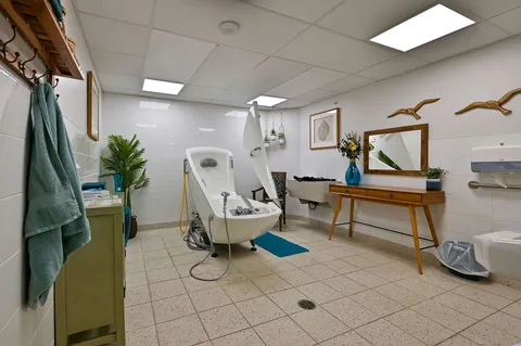 Bathing room with an accessible bathtub and tiled floor.