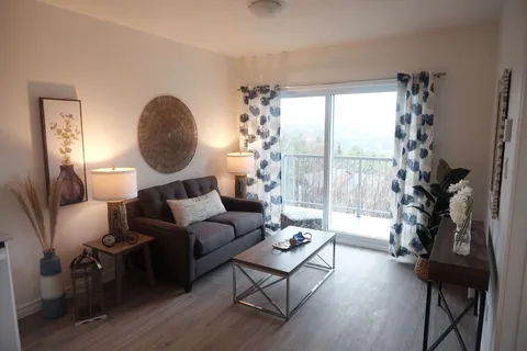 Suite sitting area with a sofa, coffee table and patio door.