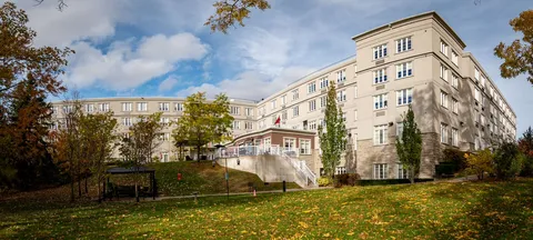 Rear of a multi-storey residence above a lawn and covered patio