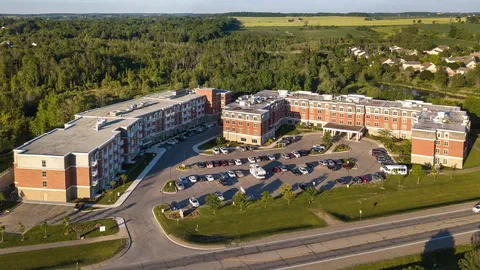 Aerial view of the residence, parking area and surrounding woodland.