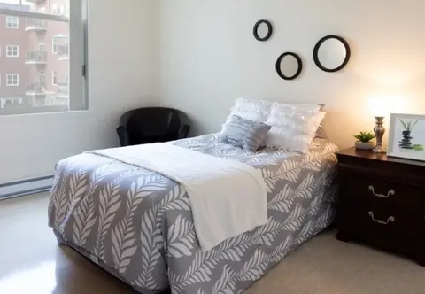 Bedroom with a double bed, bedside tables and a window.