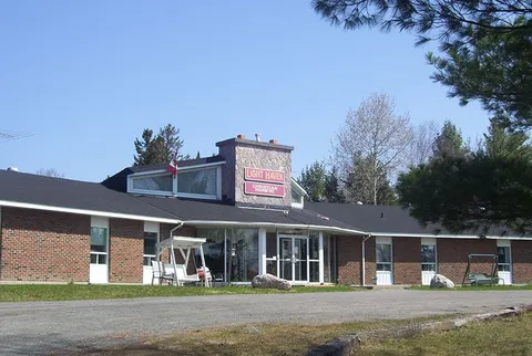 Single-storey brick building with a glazed entrance and a driveway