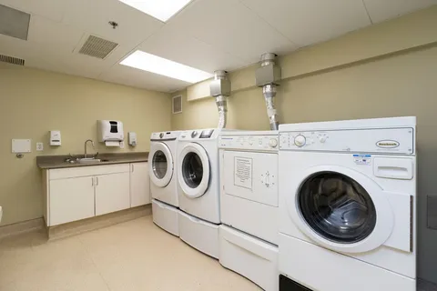 Laundry room with washers, dryers, a counter and sink