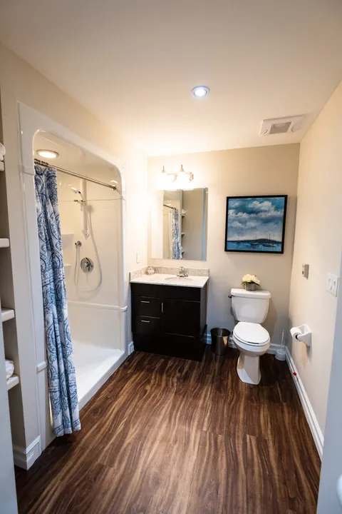 Bathroom with a sink, mirrors and a glass shower enclosure