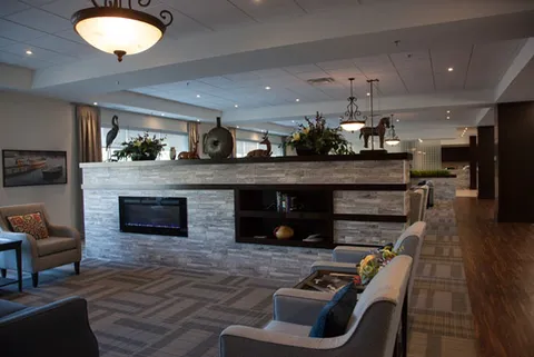 Lounge with sofas, armchairs and a stone fireplace