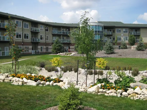 Landscaped paths and flower beds beside the residence buildings.