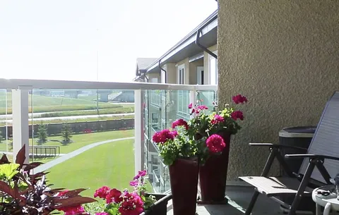 Private balcony with a chair and flowers overlooking the grounds.