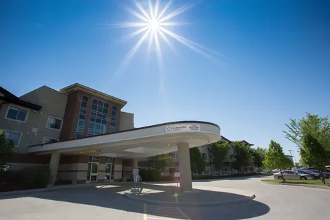 Concordia Village I entrance with a covered vehicle drop-off area.