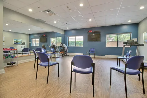 Exercise room with chairs, small weights and fitness machines