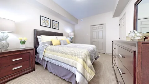 Bedroom with a bed, wooden furniture and framed floral prints