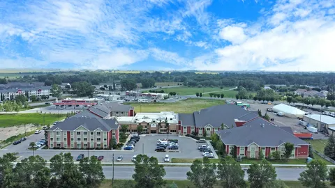 Aerial view of the building, driveway and surrounding lawns
