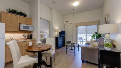 Suite kitchenette and dining table beside the living area.