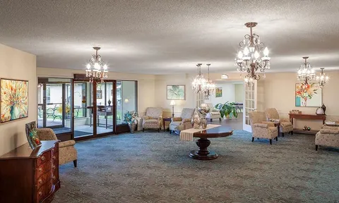 Large entrance lounge with seating and glass doors.