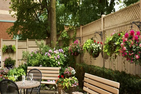 Garden patio with seating and flowering hanging baskets