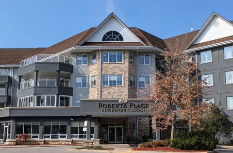 Multistorey stone building with balconies and a covered entrance