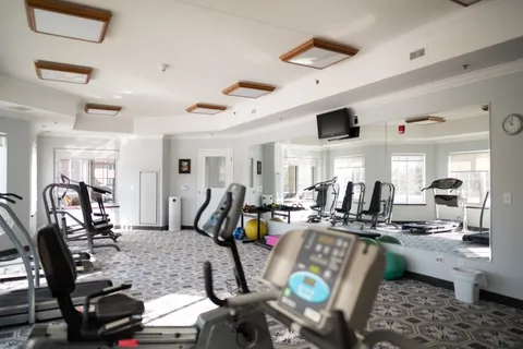 Exercise room with fitness equipment and large windows