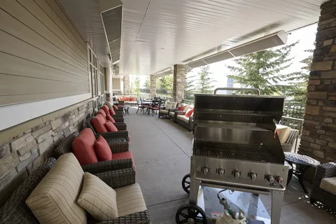 Covered patio with chairs, tables and a barbecue