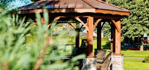 Gazebo beside lawns, planted beds, paths and residence balconies