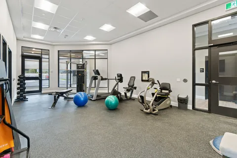 Fitness room with exercise machines and coloured exercise balls