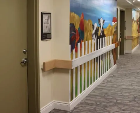 Corridor with handrails and a painted farm mural