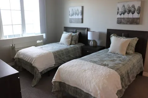Bedroom with twin beds and tall windows