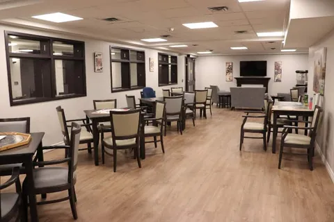 Shared lounge with tables, chairs and television