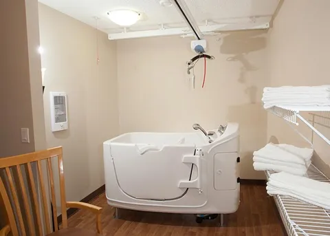 Bathing room with an accessible therapy tub and overhead lift.