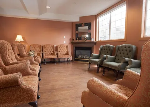 Fireplace lounge with patterned sofas and armchairs.