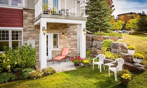 Garden lawn and patio beside a ground floor suite entrance