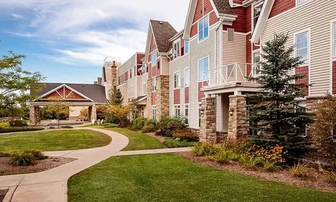 Residence facade with landscaped lawn and winding walkway
