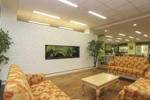 Seating area with sofas, wooden furniture and an aquarium
