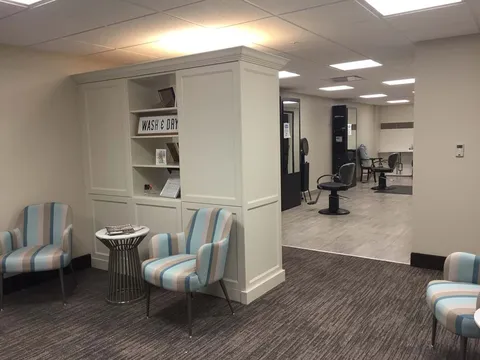 Hair salon with waiting chairs and styling stations.