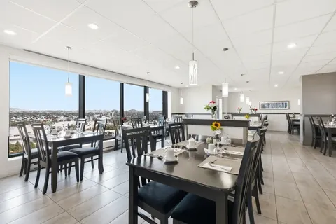 Dining room with set tables beside large windows