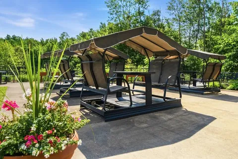 Patio with covered swings, chairs and flower pots