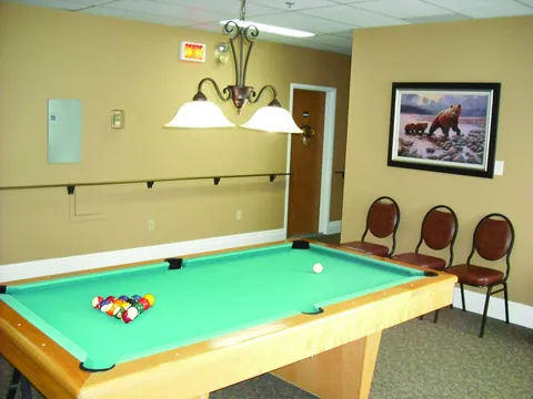 Billiard table in a room with yellow walls.