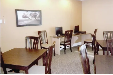 Common room with tables, chairs and public computers.